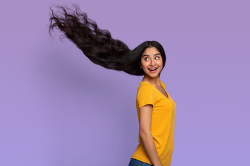 Indian woman posing with long healthy dark blowing flying hair