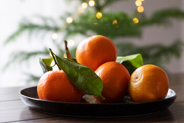 Plate of mandarin fruits with leaves