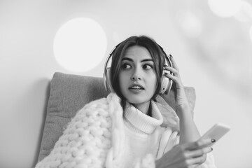 Scrolling. Portrait of beautiful brunette woman in comfortable soft longsleeve isolated on white...
