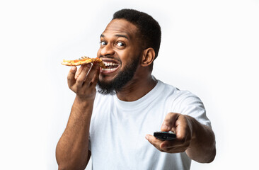African Guy Eating Pizza And Watching Television On White Background