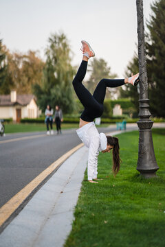 Attractive Skinny Woman Doing A Backbend While Showing A Somersault.