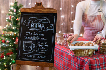 Christmas pastry shop . Woman seller, waitress selling gingerbread, marshmallows, cookies, sweets...