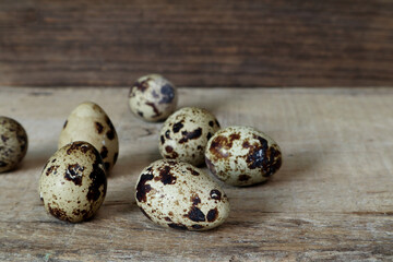 Fototapeta premium quail eggs on wooden table in the kitchen with background of old vintage wooden texture wall for making the easy menu breakfast