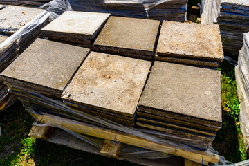 Grey pavement slabs stacked at the construction site