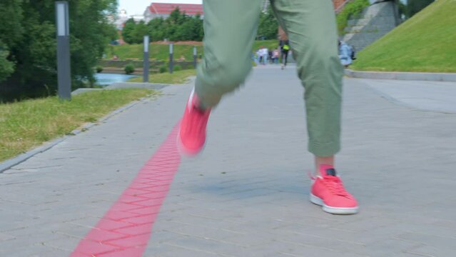 Hipster girl dancing shuffle in city park. The concept of carefree, youth culture and city life