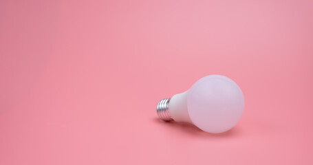A light bulb in the pink background , New idea concept