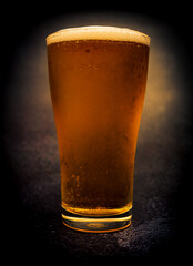 Glass of beer on dark background, Light beer in a glass,draft.Fresh light beer.Close-up.