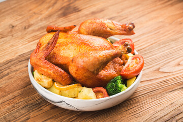 roasted chicken and vegetables on wooden table