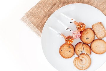 Butter cookies in a white plate on a white background.