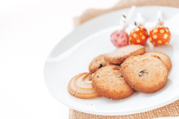 Butter cookies in a white plate on a white background.