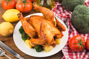 roasted chicken and vegetables on wooden table