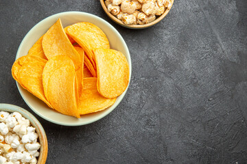 top view tasty cheese cips with different snacks on a dark background photo nut movie food cinema potato