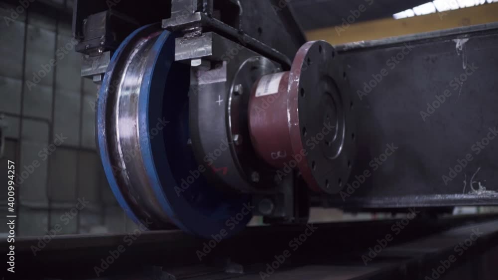 Poster wagon wheels on rails at factory. clip. run wheels of wagon on rails at machine-building plant. deve