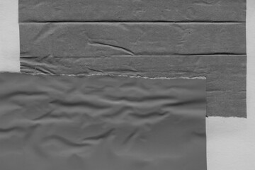 Black torn paper collage close-up. Texture made from various paper and cardboard parts. Damaged old...