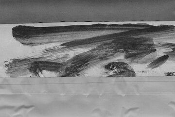 Black torn paper collage close-up. Texture made from various paper and cardboard parts. Damaged old paper background. Vintage blank wallpaper. Material design backdrop.