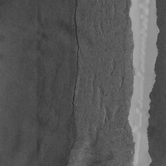 Black torn paper collage close-up. Texture made from various paper and cardboard parts. Damaged old paper background. Vintage blank wallpaper. Material design backdrop.