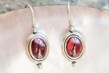 pair of sterling silver garnet mineral earrings on natural background