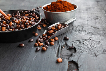 .Roasted coffee beans with coffee powder and coffee cups.