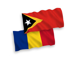 National vector fabric wave flags of Romania and East Timor isolated on white background. 1 to 2 proportion.