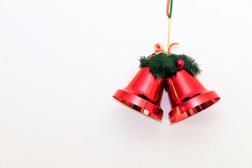 A close up of red christmas bells on white background, copy space