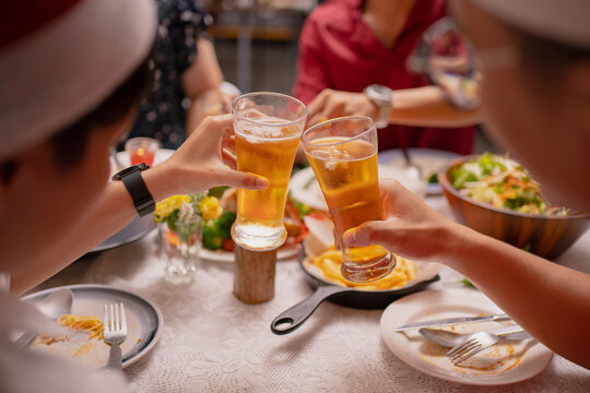 Group of Asian friends have a dinner party and beer after work at home.