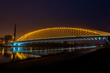 View of street lighting on "Troja bridge" on the Vltava river in the city of Prague at night 