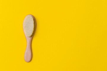 Natural soft goat bristle hair sweeping brush men beard on yellow background. Top view, space for your text