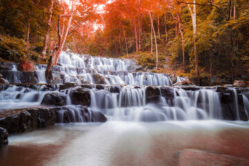 Beautiful deep forest waterfall are arranged like steps at Sam lan waterfall National Park Saraburi Thailand in autumn