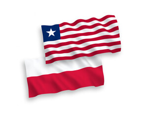 National vector fabric wave flags of Liberia and Poland isolated on white background. 1 to 2 proportion.