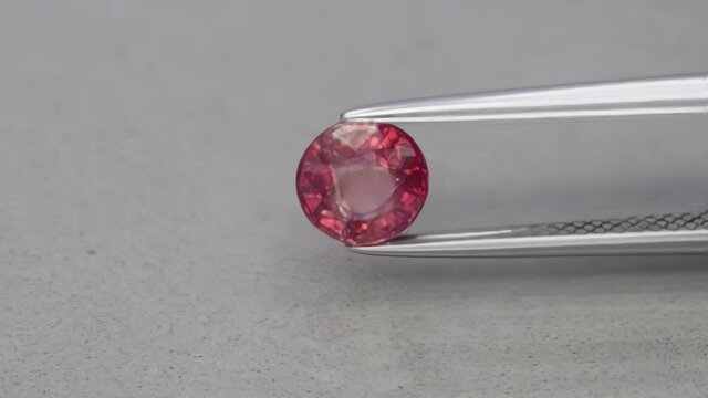 natural round red sapphire on the grey background