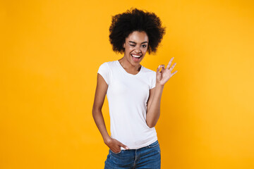 Happy african american girl winking and showing ok sign