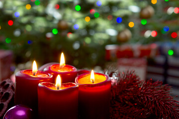 Four red candles for Advent. Christmas background.