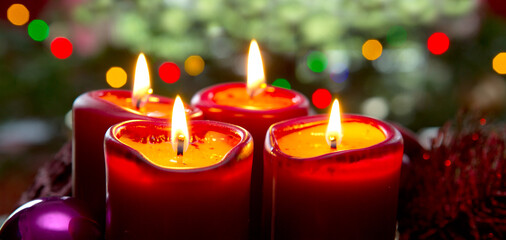 Four red candles for Advent. Christmas background.
