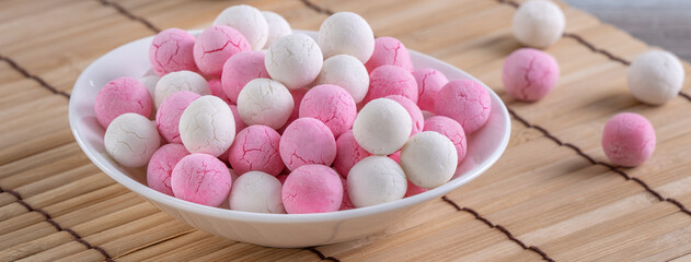 Raw red and white tangyuan on wooden table background for Winter solstice food.