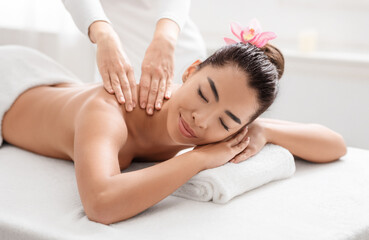 Obraz na płótnie Canvas Wellness Concept. Attractive Asian Woman Relaxing During Thai Massage Session At Salon
