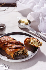 Swirl brioche with poppy seeds served with butter and jam. Poppy seed braided or roll bread, Babka. Traditional sweet Christmas bread