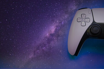 Video games white gaming controller joystick isolated on blue galaxy background, top view with copy space © estefania chan