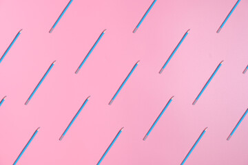 Pattern sharpened blue pencils for sketching or drawing on pink background. Banner or background for school, office or copywriting