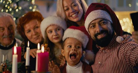 Happy family taking selfie on Christmas dinner