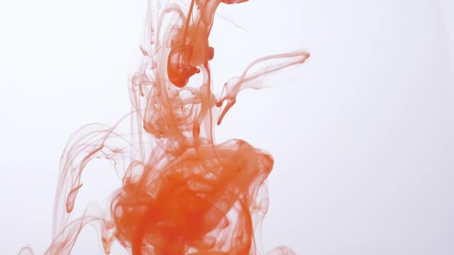 drop orange ink paint in water slow motion