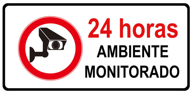 A sign that indicates in Portuguese Language : MONITORED PLACE BY CAMERA 24 HOURS . AMBIENTE MONITORADO POR CAMERAS 24 HORAS 