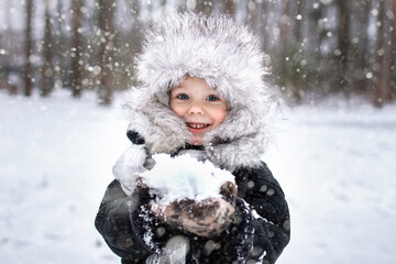 Portrait of a boy in a fur winter hat. Winter, outdoor, snow
