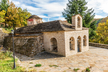 Fototapeta na wymiar The picturesque moni Rogovou during fall season the stone build church is located near tsepelovo aboves vikos gorge on Tymfi mounain t, Zagori, Epirus, Greece.