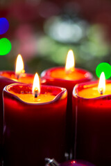 Four red candles for Advent. Christmas background.