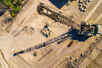 Aerial Top Down view of mining operations and equipment to support metal processing facilities.  Crane view crushing material.