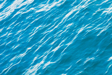 Blue sea surface background with waves. Silky texture of ocean water. Caribbean lifestyle themes