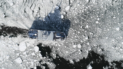  Passenger cruise ship sailing through the icy waters. A small boat among ice blocks. Ferry moving...