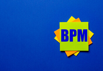 BPM is written on bright stickers on a blue background