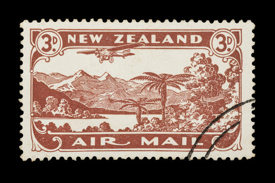 A New Zealand air mail stamp of 1931 showing a plane flying over a scenic landscape