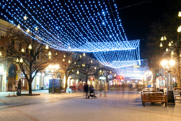 Fototapeta na wymiar Colorful winter illumination (night city lights) in the tourist center of Novi Sad, Serbia